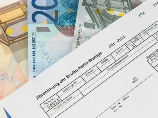 Lohnabrechnung für Juli mit Euro-Scheinen. Der niedrige Lohn lässt vermuten, dass der Arbeitgeber zu wenig zahlt.